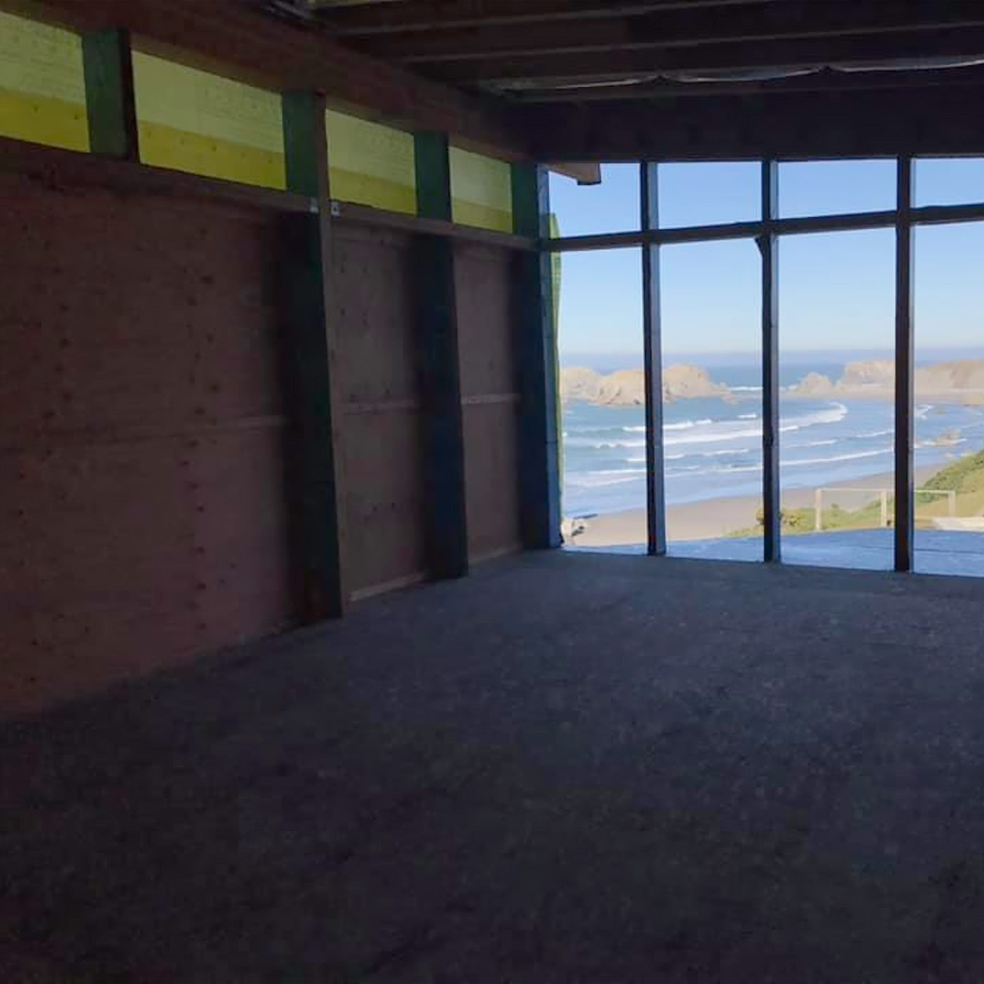 bright luxury mid century modern kitchen on the Oregon coast with flat panel cabinets, quartz countertops, and open layout facing the beach