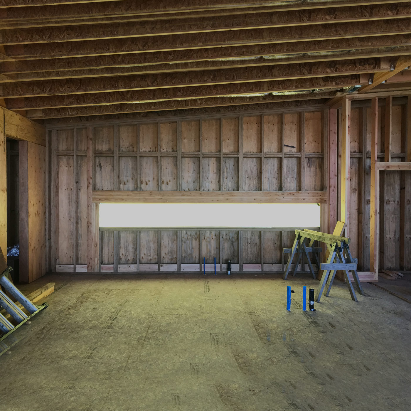 bright mid century modern kitchen on the Oregon coast with flat panel cabinets, quartz countertops, and open layout facing the beach
