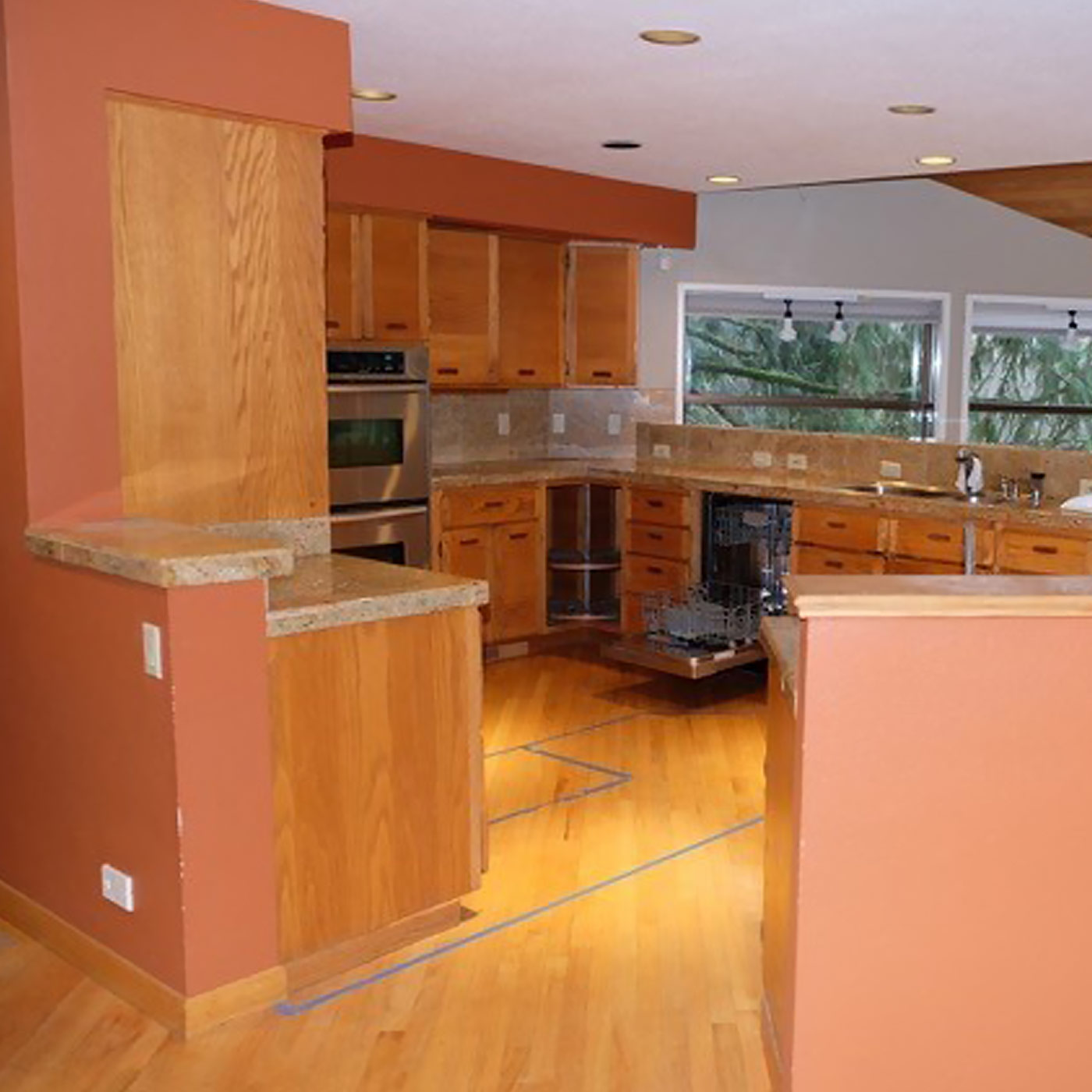 A completely remodeled new modern craftsman kitchen in Portland featuring beautiful wood tones along with entertainment bar