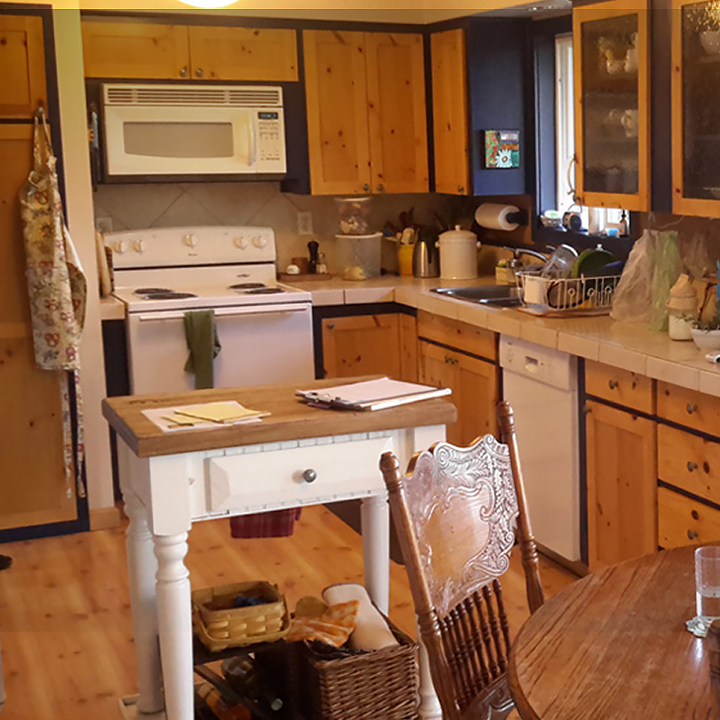 Brand new remodeled vintage farmhouse kitchen in newberg features cottage and retro cabinetry and light fixtures