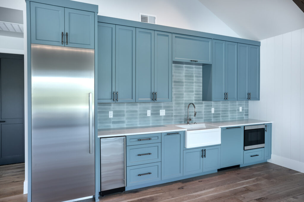 modern farmhouse guest house built in kitchen with blue cabinets